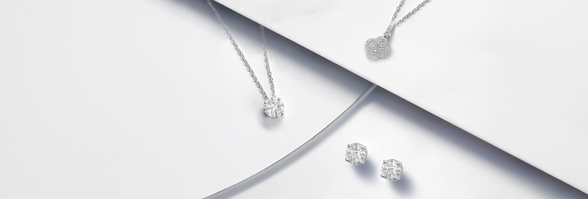 Two necklaces and earrings from the Illusion collection. Small marquise and round brilliant cut diamodns set together to maximise diamond impact and appear as one larger diamond.