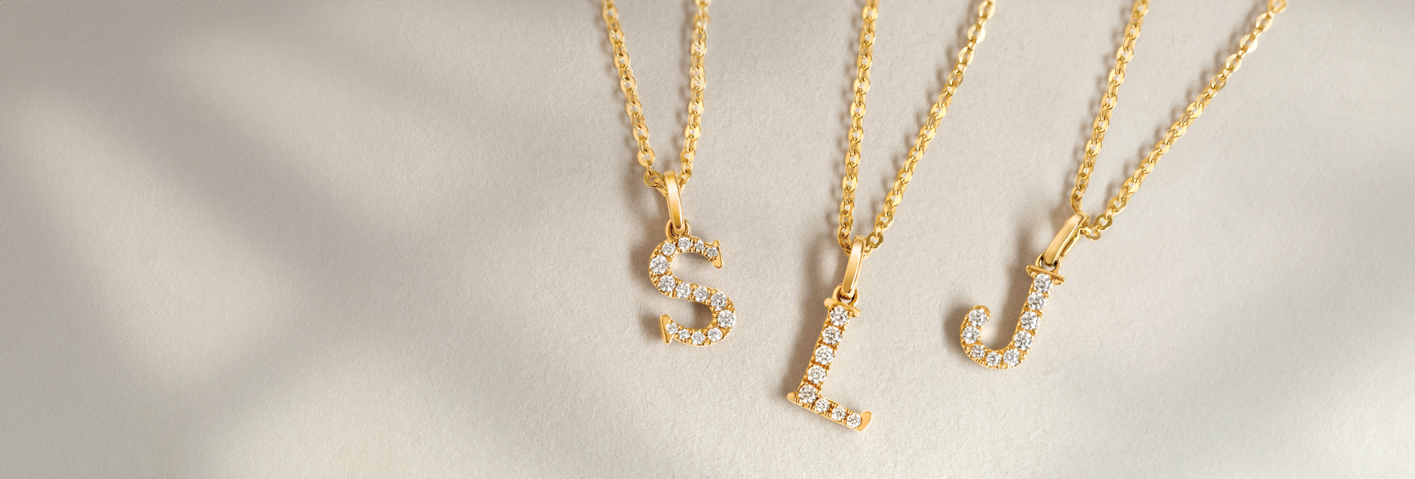 Love Letters jewellery_18ct yellow gold, 18ct white gold initial necklaces; letter s, letter l, letter j