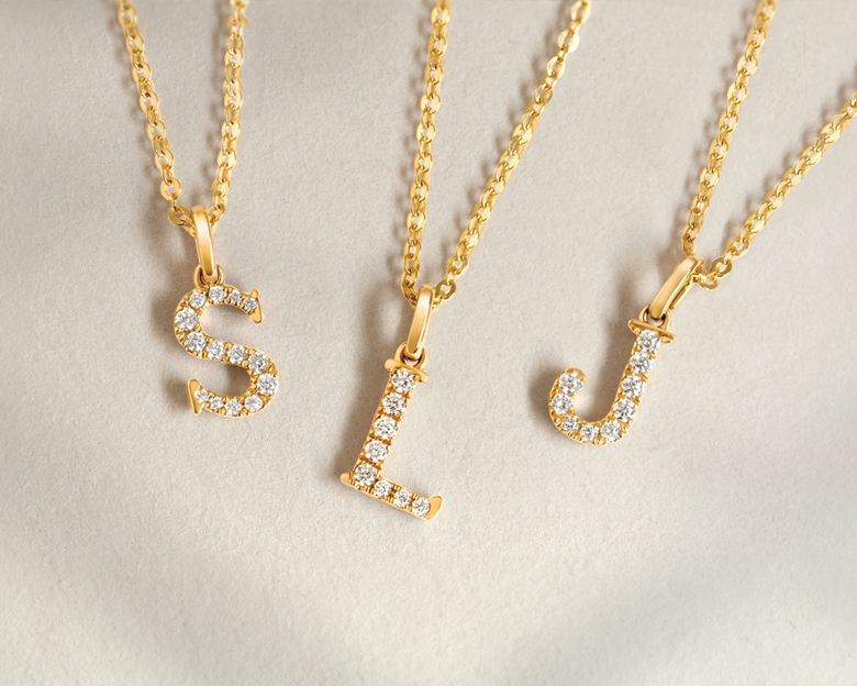 Love Letters jewellery 18ct yellow gold, 18ct white gold initial necklaces; letter s, letter l, letter j