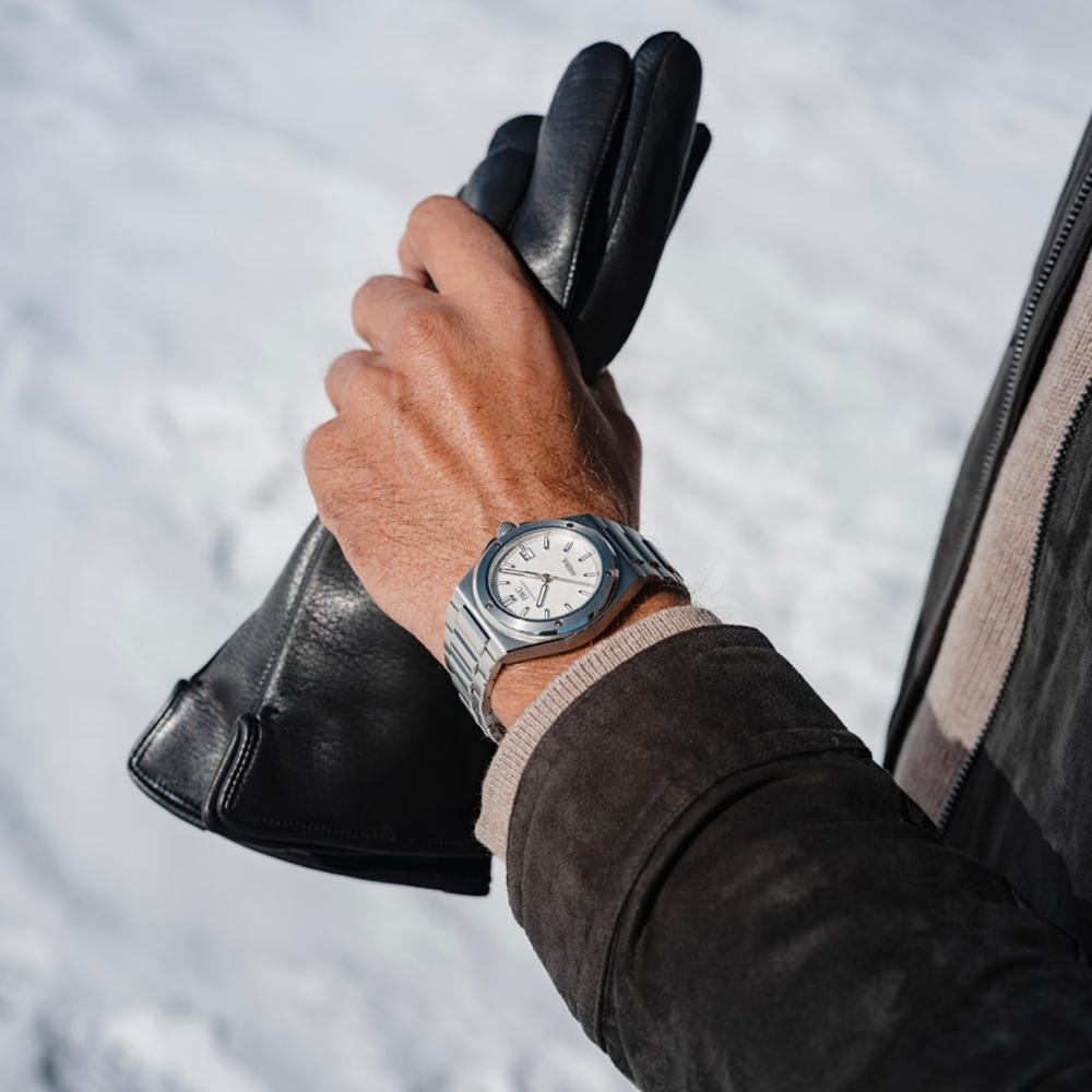 Wrist wearning IWC Ingenieur Automatic 40 Watch with Silver White dial IWC328902 at Lunn's Jewellers. Holding leather glove. 