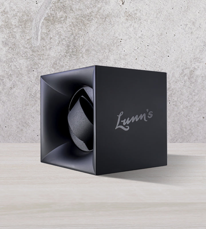 Navy Lunn's branded watch winder box on cool tone background
